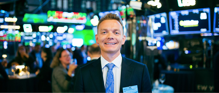 A male employee standing in the middle of an active equity market landscape