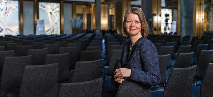 Ida Wolden Bache sitting on a chair in the room where the annual speech is held