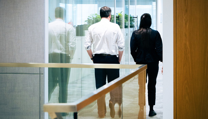 Man and woman walking away down a corridor 