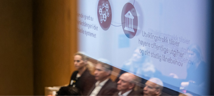 Reflection of a section of an audience showing a stage monitor with graphics