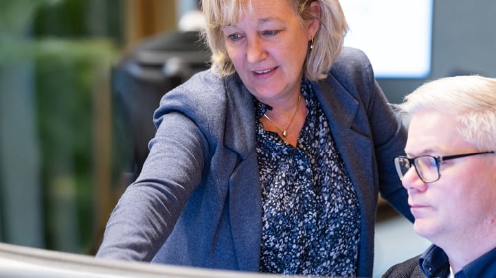 Woman and man looking at desktop computer screen
